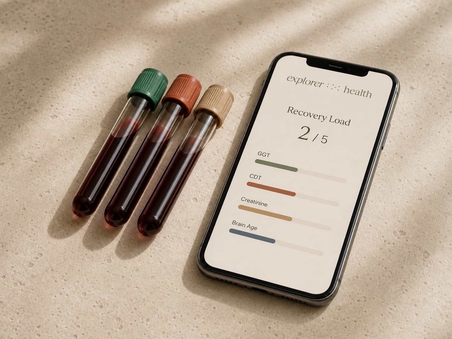 Three blood collection tubes beside a phone showing Recovery Load and substance-relevant biomarker results