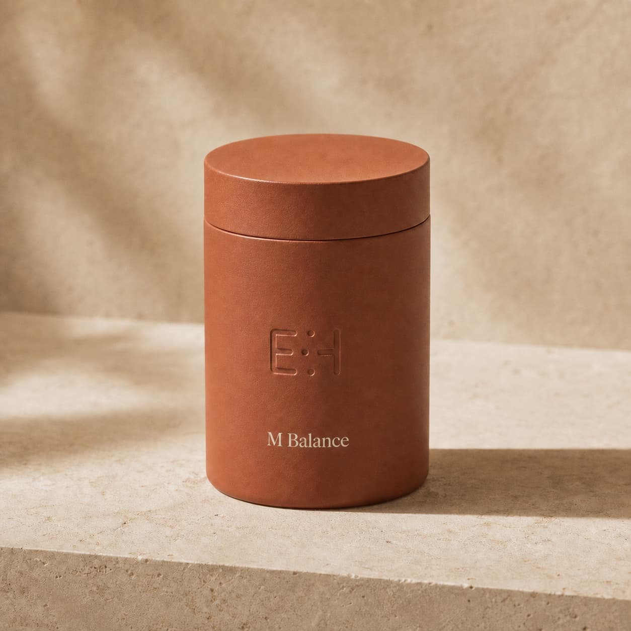Terracotta M Balance bottle on warm travertine